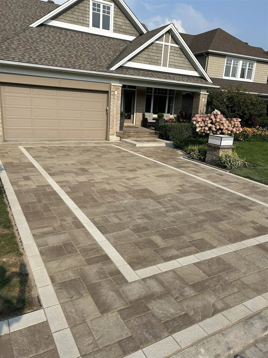 An interlock driveway finished with a double contrasting band running to the garage