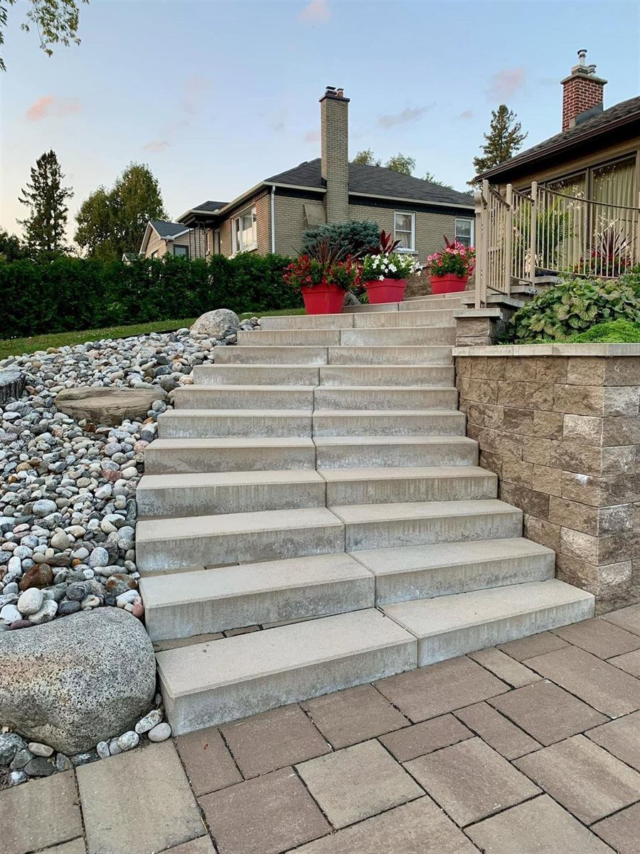 A retaining wall holding a planted bank beside a run of stone steps
